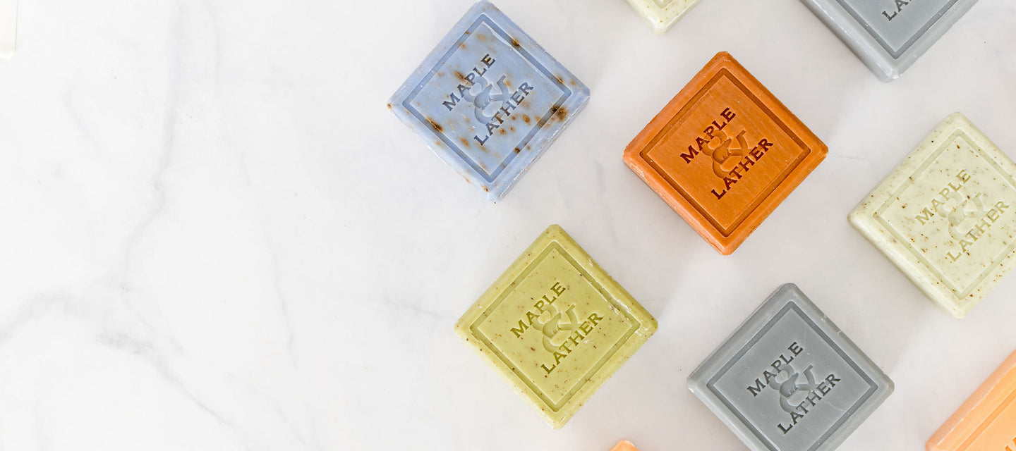 triple-milled soaps on top of a luxurious white marble countertop.